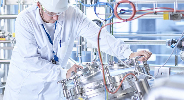SCHOTT products improve industrial safety and inspection standards Man in white overalls and hat working in an industrial plant